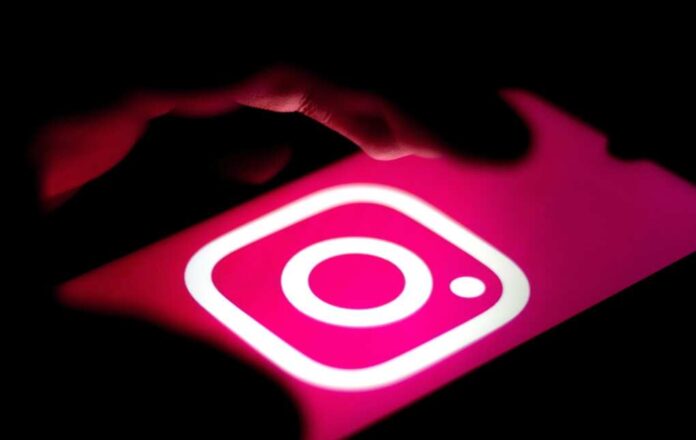 Instagram,Mobile,App,,Close-up,Of,Hand,Holding,Phone,With,Instagram