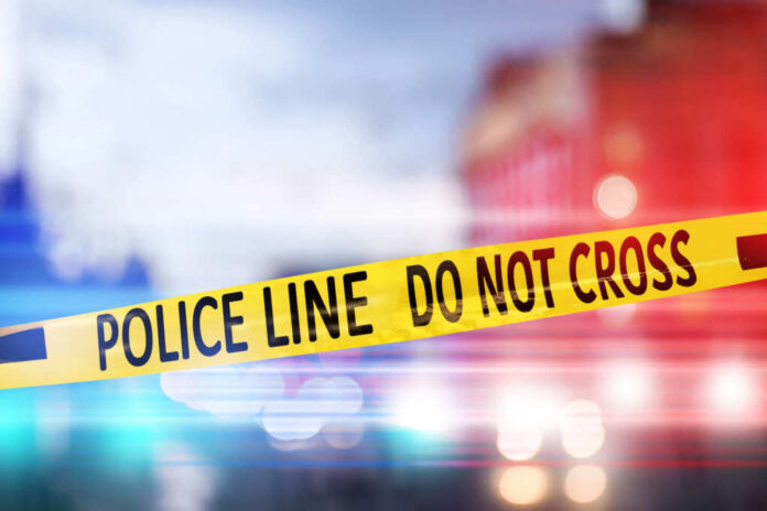 Yellow,Law,Enforcement,Tape,Isolating,Crime,Scene.,Blurred,View,Of