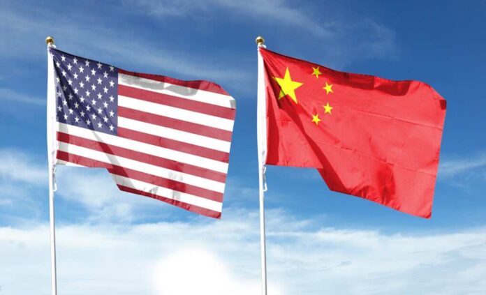 American,Flag,And,Chinese,Flag,On,Cloudy,Sky.,Fly,In