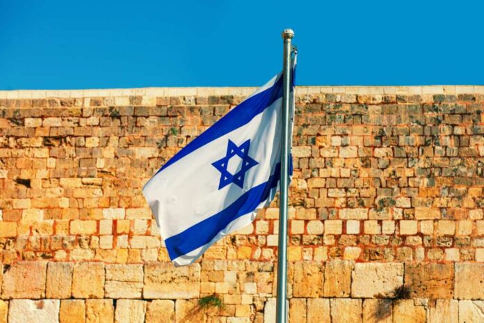 Israeli,Flag,Fluttering,Against,Western,Wall,In,Jerusalem,In,Israel