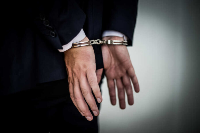 Businessman,Arrested,With,Handcuffs,On,Back,For,Corruption,And,Stealing