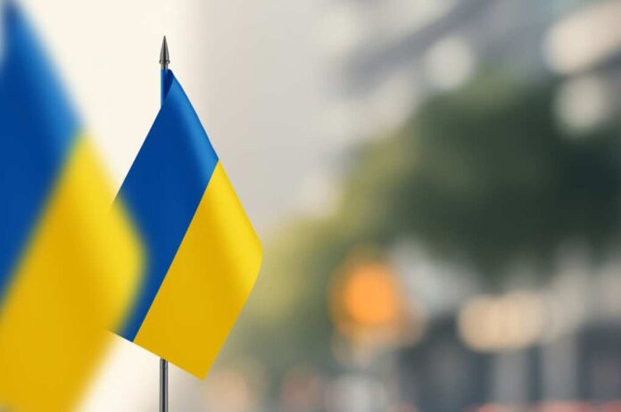 Small,Flags,Of,Ukraine,On,A,Blurred,Background