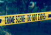 Yellow crime scene tape reading DO NOT CROSS