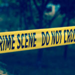 Yellow crime scene tape reading DO NOT CROSS