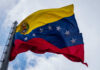 Venezuelan flag waving against a blue sky