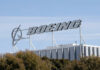 Boeing company sign displayed on a building against a clear blue sky