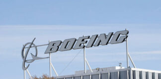 Boeing company sign displayed on a building against a clear blue sky