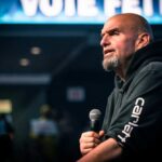 Fetterman Ditches Hoodie–Stuns Dems Speaker addressing an audience with a microphone