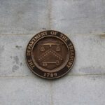 Trump’s Treasury Strikes Rogue Swiss Bank Bronze seal of the Department of the Treasury mounted on a stone wall