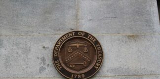 Bronze seal of the Department of the Treasury mounted on a stone wall