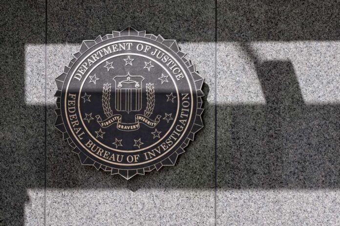 FBI seal mounted on a granite wall with shadows