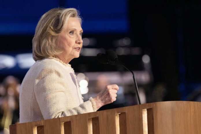 A woman speaking at a podium with a microphone during a public event
