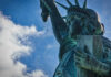 Close-up view of the Statue of Liberty against a blue sky