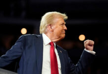 Iranian Assassin’s Plan BACKFIRES: FBI Sting A man in a suit making a celebratory gesture during a speech