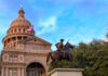 Statue of a rider in front of the Texas State Capitol building under a blue sky