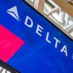 Delta Airlines logo displayed on an airport screen