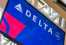 Delta Strips Congress of Airport Privileges! Delta Airlines logo displayed on an airport screen