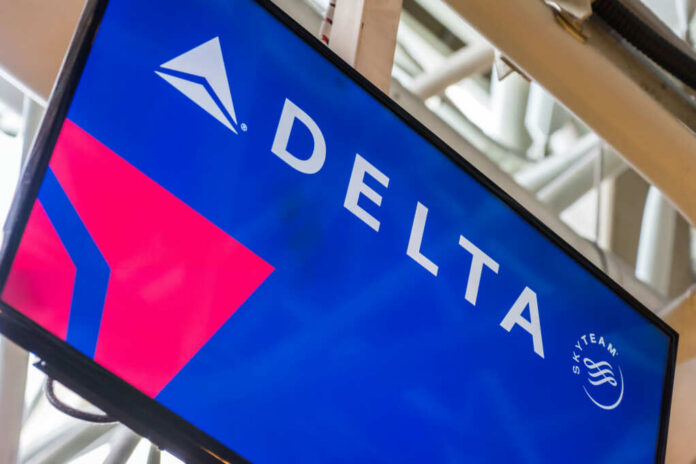 shutterstock_1498993412.jpg Delta Airlines logo displayed on an airport screen
