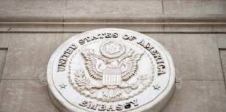 Seal of the United States Embassy displayed on a wall