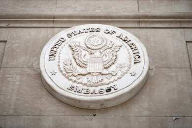 Seal of the United States Embassy displayed on a wall