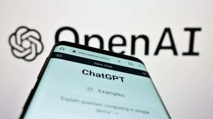 Close-up of a smartphone displaying the ChatGPT interface with the OpenAI logo in the background