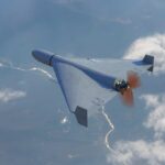 U.S. Forces Saved by Ukrainian Drone Experts A drone flying high above the clouds with a visible propeller