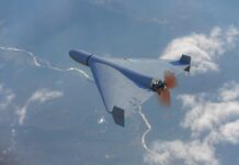 A drone flying high above the clouds with a visible propeller