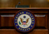 Close-up of the United States Senate seal on a wooden podium