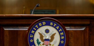 Close-up of the United States Senate seal on a wooden podium