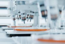 Sperm Whales’ Secret Weapon Revealed! Automated laboratory equipment with robotic arms dispensing liquids into petri dishes