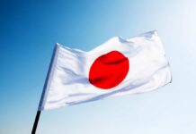 Middle East Chaos Triggers Japan’s Coal Comeback Japanese flag with a red circle on a white background waving against a blue sky