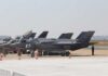F-35 military jets parked on an airfield with crew members nearby