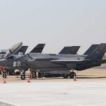 Stealth Fighters Clash: Unexpected Drill at Hotspot F-35 military jets parked on an airfield with crew members nearby