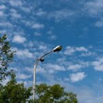 A streetlight against a backdrop of blue sky and scattered clouds