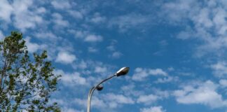 A streetlight against a backdrop of blue sky and scattered clouds