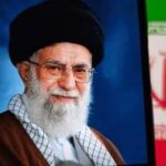 Portrait of a political leader with a black turban and glasses