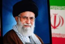 Portrait of a political leader with a black turban and glasses