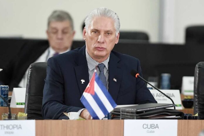 Cuban representative at a political meeting with a flag in front