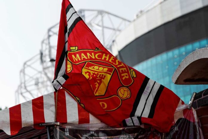 Manchester United flag waving in front of a stadium