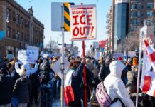 Masked Rioters Clash Hard at ICE Facility Crowd of protesters holding signs at a rally against ICE