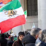 Protester Massacres — The Grim Truth Inside Iran Crowd holding Iranian flags during a protest