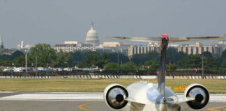 A private jet on the runway with the Capitol building in the background