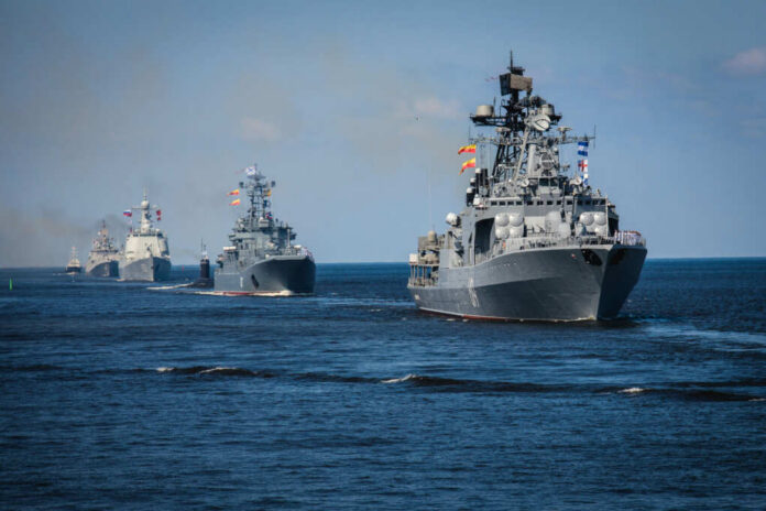A fleet of military ships sailing in the ocean