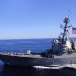 Navy Blockade Threatens Iran Showdown A naval destroyer sailing in the ocean with an American flag