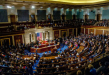 A large gathering of officials in a congressional chamber during a legislative session