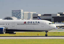 Delta Airlines airplane taxiing on the runway at an airport