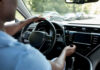 Drivers hands on the steering wheel inside a car