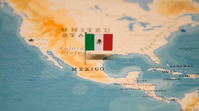 Map of North America with a flag of Mexico pinned on it