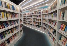 Interior view of a modern library with bookshelves filled with colorful books