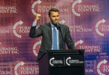 Speaker at a podium delivering a political speech